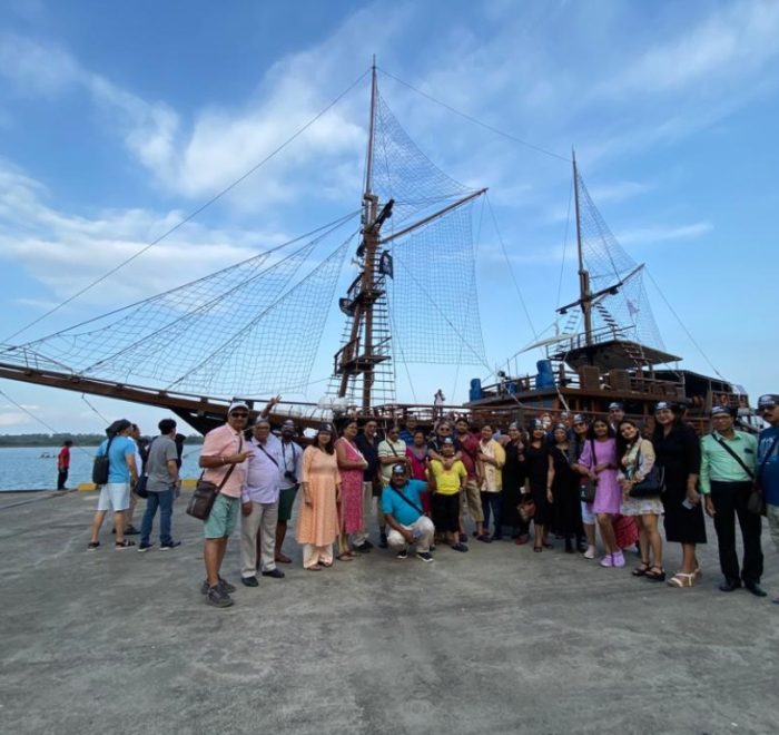 group tour photo in front of Phinsi vessel during a Pirate Dinner Cruise, Bali, Indonesia